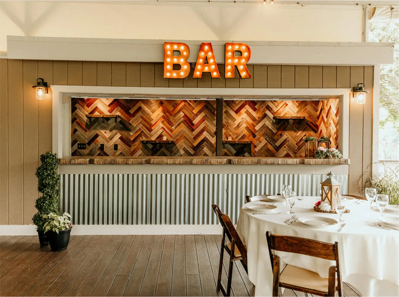 Warm and inviting interior of Hef's Hut Bar & Grill, featuring rustic d&eacute;cor, a stocked bar, and comfortable dining tables.