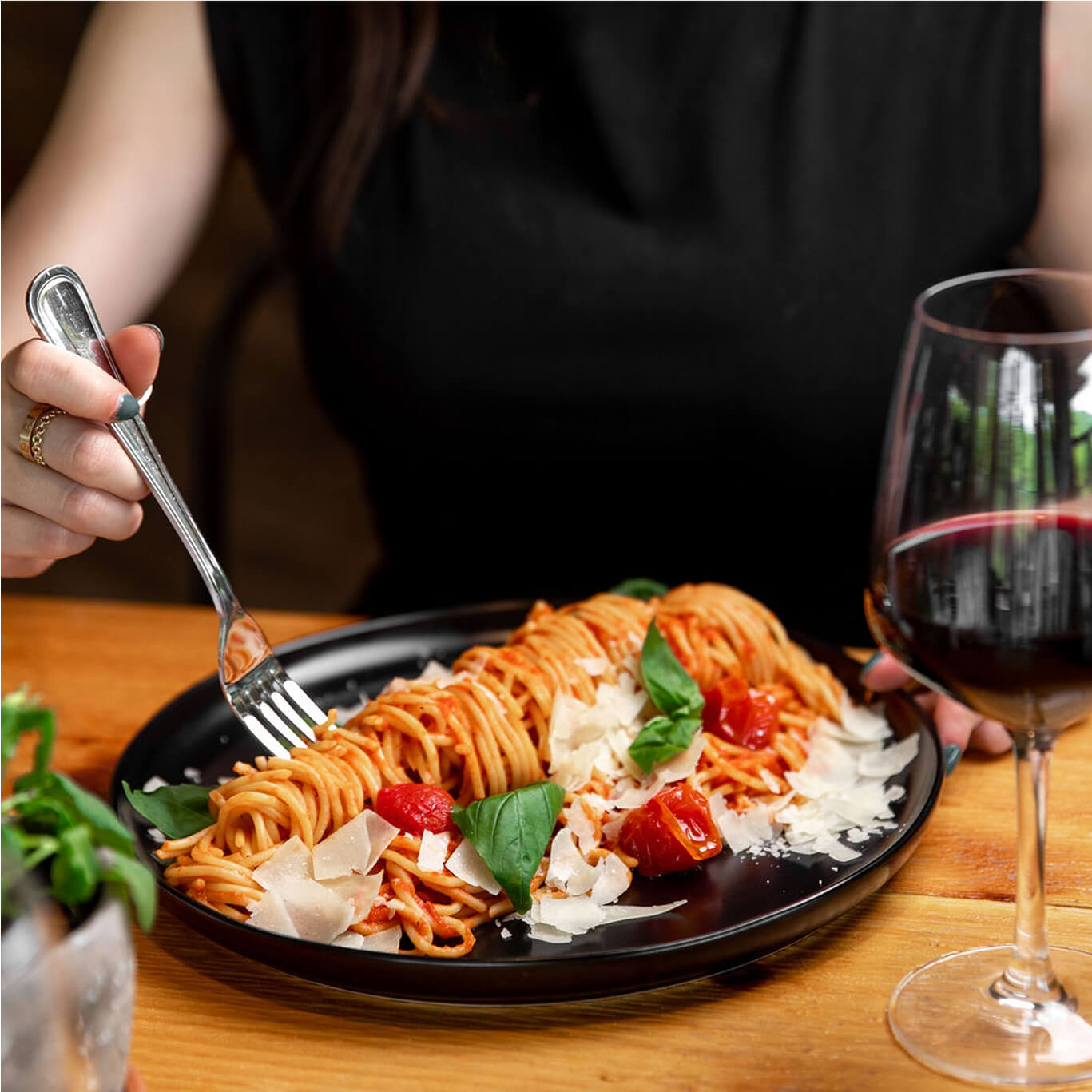 Close-up of a woman enjoying a delicious dish at Hef’s Hut Bar & Grill in Vernon, NJ, savoring every bite of the flavorful meal.