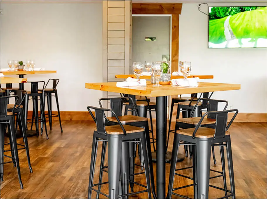 Interior dining space at Hef's Hut featuring a cozy restaurant and bar area with warm lighting, wood accents, and a welcoming atmosphere.