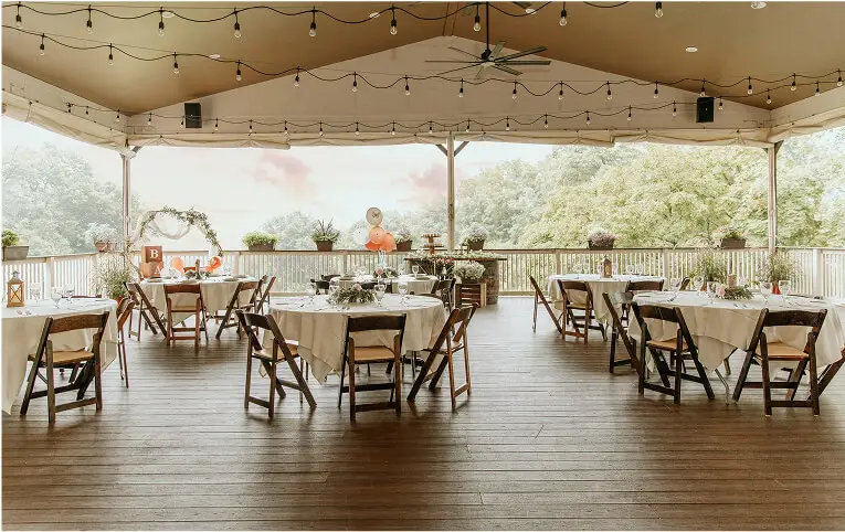Outdoor patio tables at Hef's Hut Bar & Grill in Vernon, NJ, set for casual dining with umbrellas and scenic surroundings.
