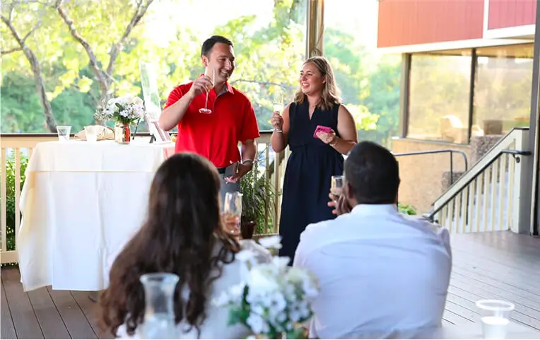 Guests enjoying a lively wedding celebration at Hef's Hut patio in Vernon, NJ, with laughter, dancing, and a joyful atmosphere under outdoor lighting.