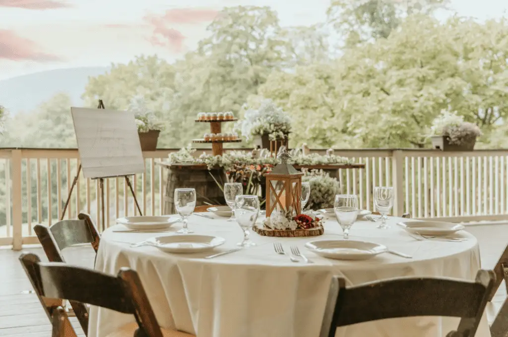 Wedding table setup on the patio at Hef's Hut in Vernon, NJ, decorated with elegant place settings and floral arrangements.