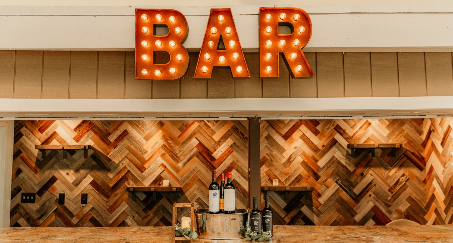 Hef's Hut bar with a variety of drinks on display, highlighting a lively atmosphere at one of the best places for birthday parties in the area.